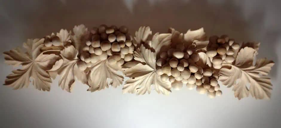 Limewood grape clusters and vine leaves in deep relief, a custom wood carving by Alexander Grabovetskiy.