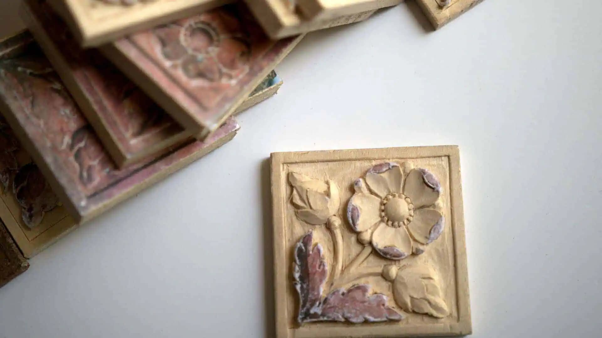 Square limewood tile with a carved wild rose, custom wood carving by Alexander Grabovetskiy.