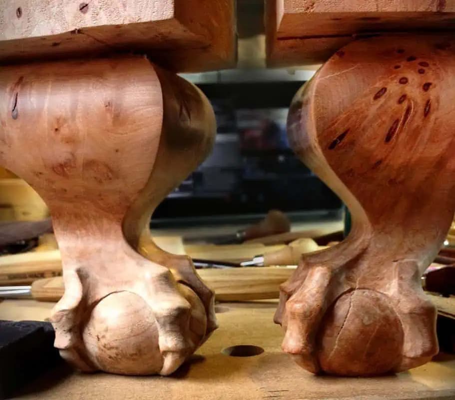 Two ball-and-claw cabriole table legs hand-carved by Alexander Grabovetskiy as a custom wood carving.