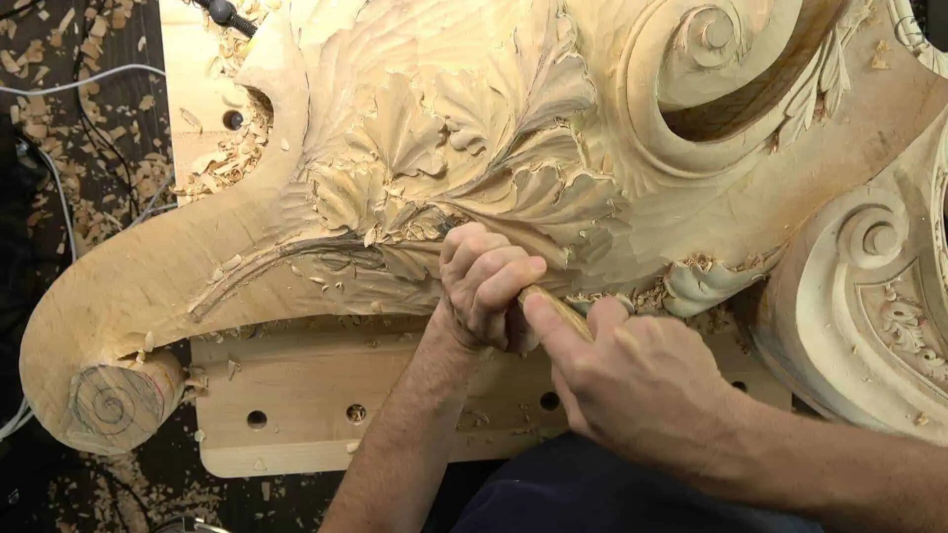 Alexander Grabovetskiy shaping acanthus leaves and volutes on a capital in this custom wood carving.