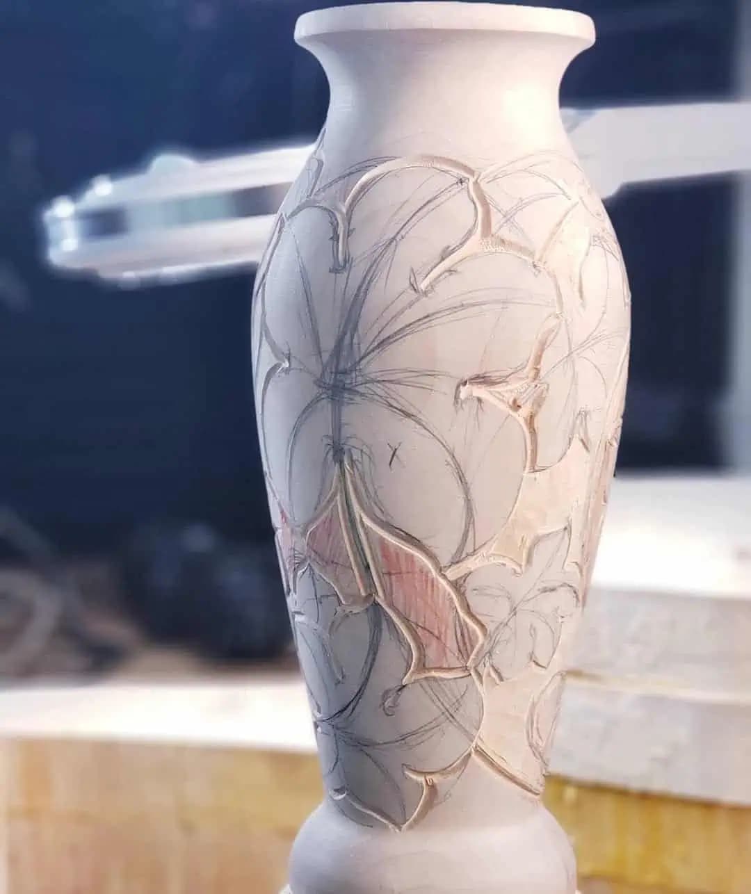 Limewood vase carved with lilies in progress by Alexander Grabovetskiy, a custom wood carving piece.