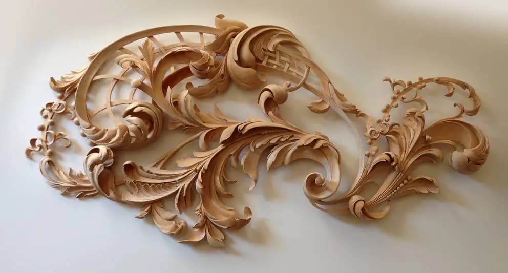 Flowing acanthus scrollwork relief carved in limewood by Alexander Grabovetskiy as custom wood carving.