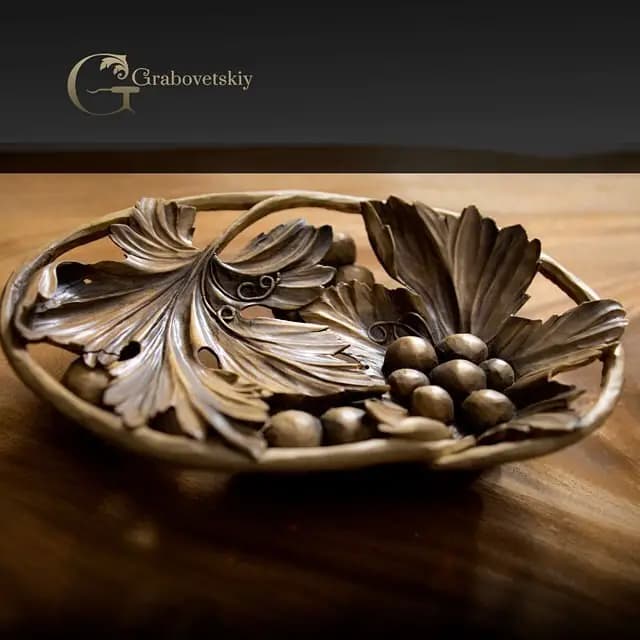 Limewood dish carved with grape clusters and leaves by Alexander Grabovetskiy, a custom wood carving.