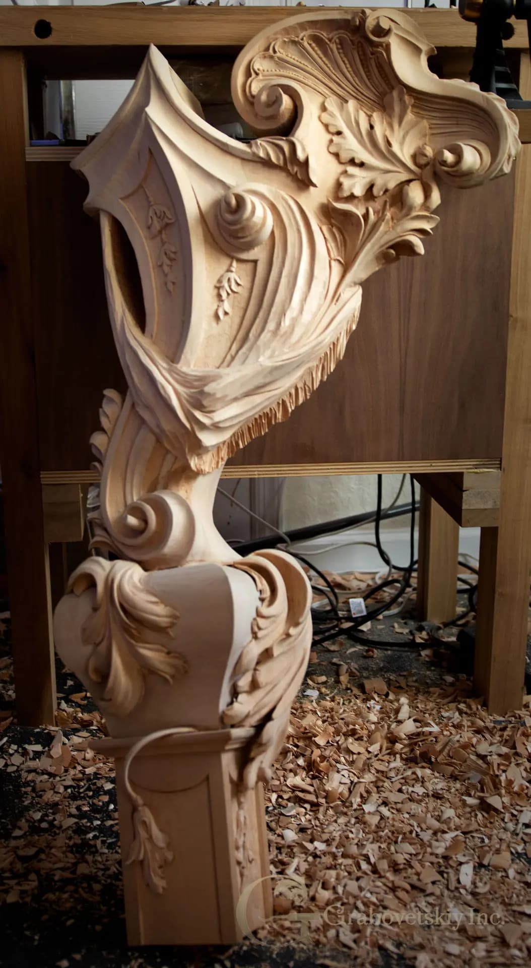 Rococo scrollwork and acanthus newel post by Alexander Grabovetskiy, a custom wood carving in limewood.