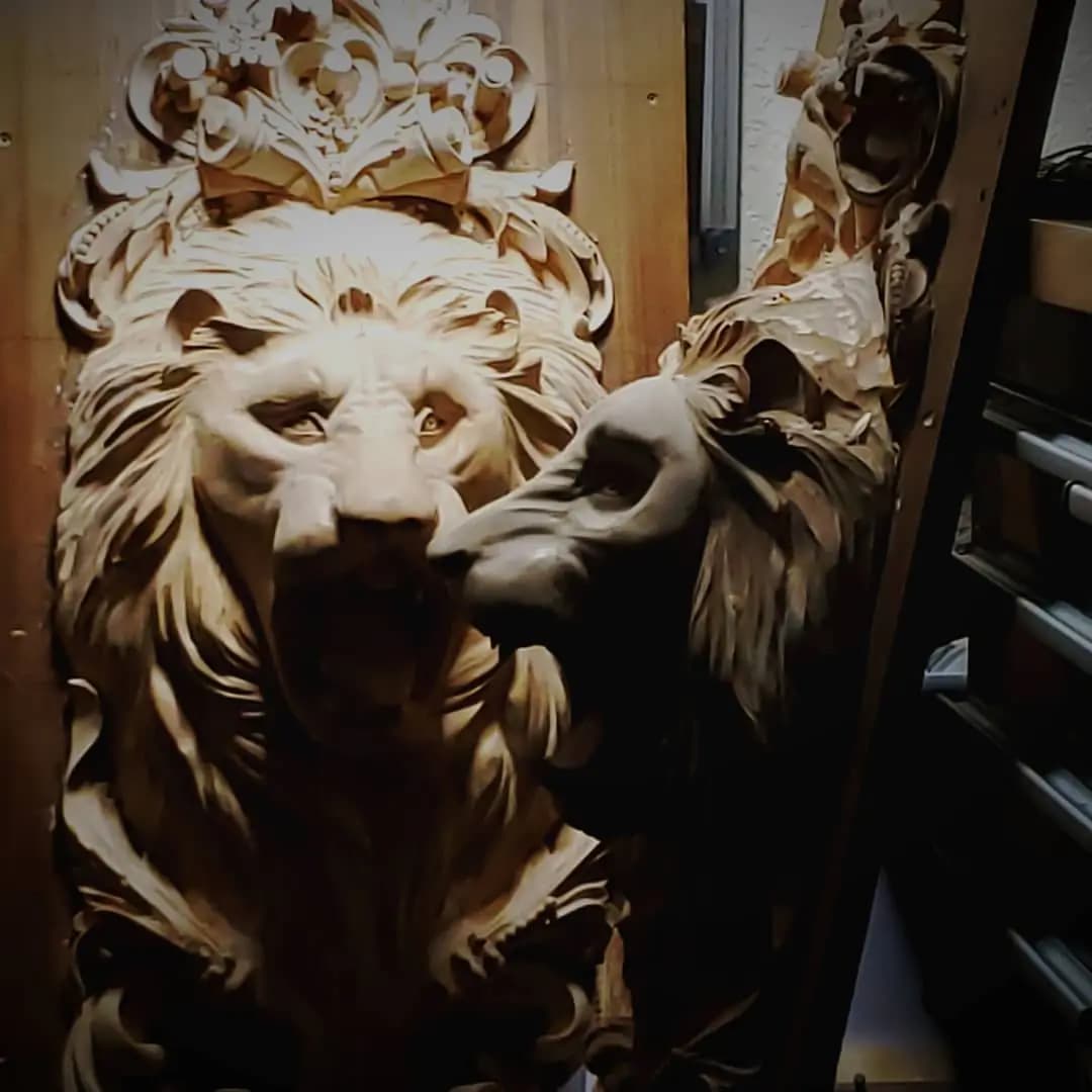Limewood lion head with crown and flowing mane carved by Alexander Grabovetskiy as a custom wood carving.