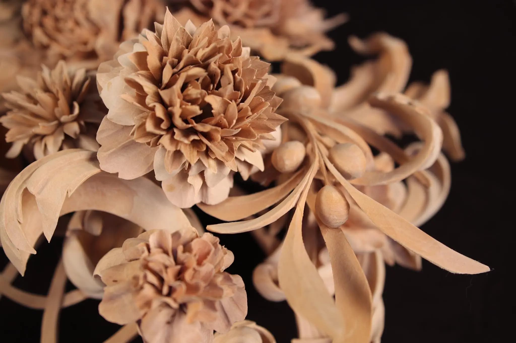Hand-carved limewood blossoms and leaves by Alexander Grabovetskiy, a custom wood carving with deep undercut petals.